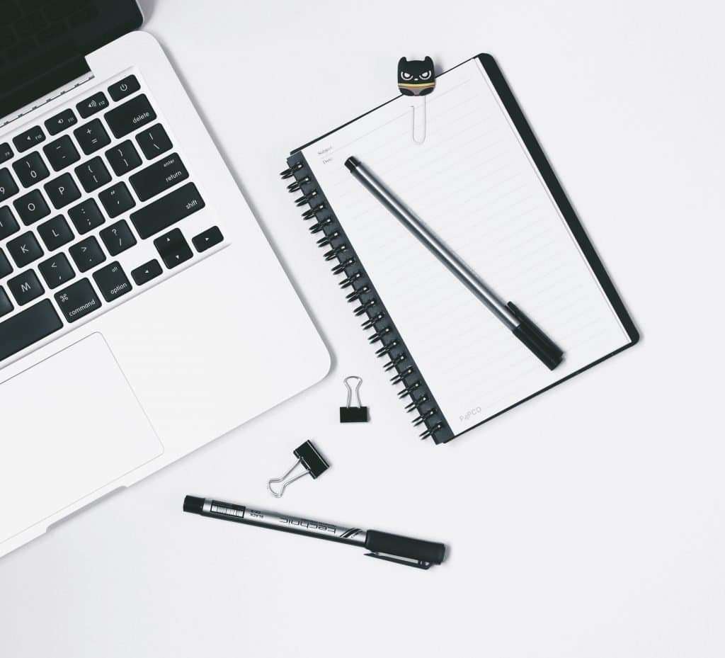 laptop with pen and notepad