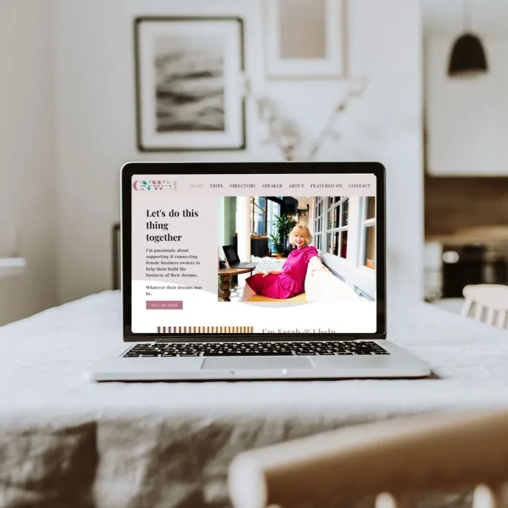 Laptop displaying a website for a service-based business, on a white table in a modern, stylish home office.