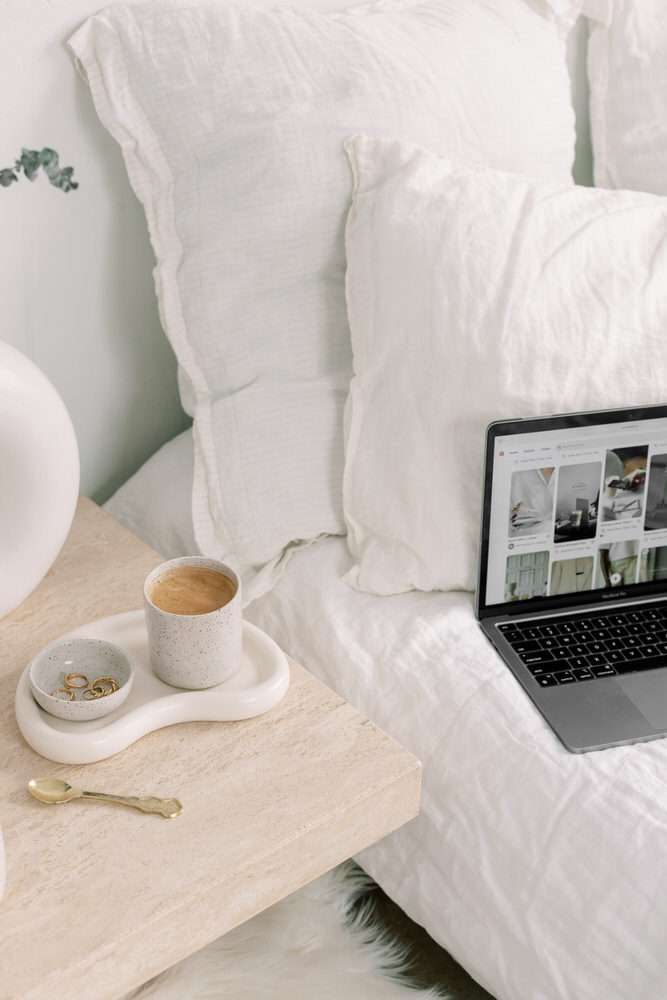 Cozy bedside with laptop and coffee