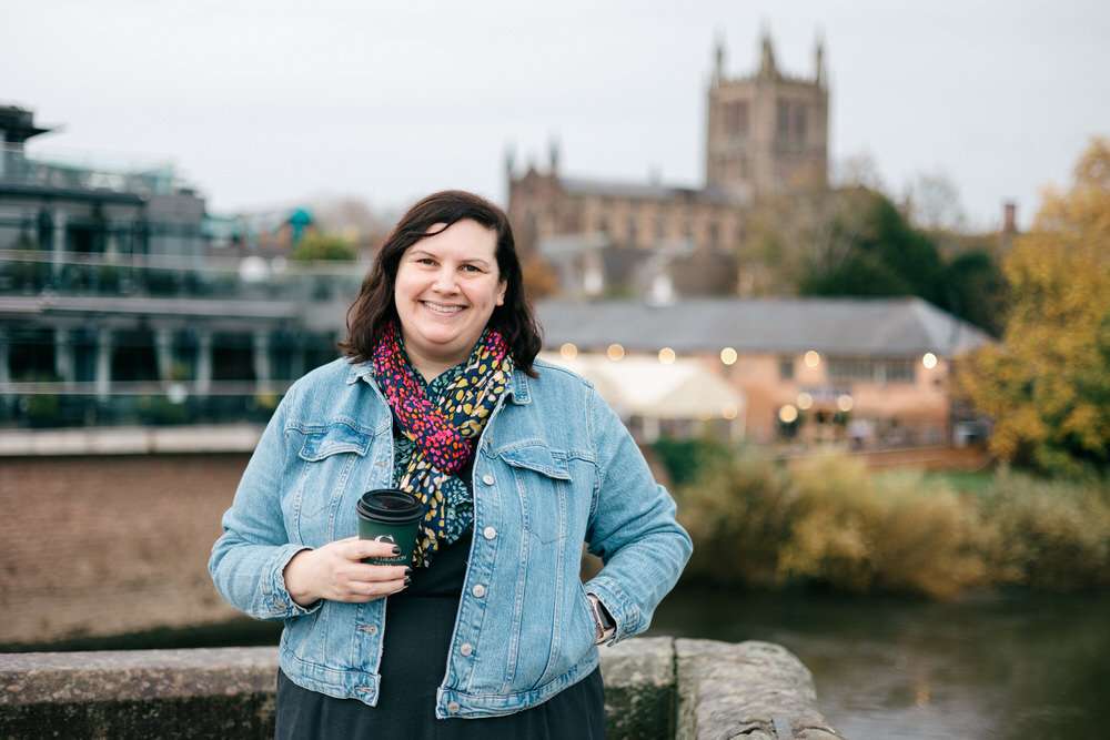 Lyndsey holding coffee near Hereford Cathedral.